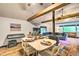 Cozy dining area featuring wood floors, exposed beams, and open flow to living space at 7559 S Turkey Creek Rd, Morrison, CO 80465