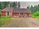 Charming exterior of home features stone accents, green door, wood deck and mature trees at 7559 S Turkey Creek Rd, Morrison, CO 80465