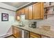 Kitchen area with stainless steel sink, granite counters and light wood cabinets at 7559 S Turkey Creek Rd, Morrison, CO 80465