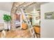 Functional kitchen with stone archway, ladder to loft, and modern appliances, offering both charm and convenience at 7559 S Turkey Creek Rd, Morrison, CO 80465