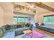 Cozy living room featuring exposed beams, large artwork, and comfortable seating area with accent pillows at 7559 S Turkey Creek Rd, Morrison, CO 80465