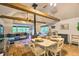 Open concept living area with vaulted ceilings, exposed beams, and hardwood floors, offering a cozy and inviting atmosphere at 7559 S Turkey Creek Rd, Morrison, CO 80465
