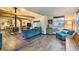 Inviting living room with rustic wood floors, wood burning stove, and comfortable blue seating at 7559 S Turkey Creek Rd, Morrison, CO 80465
