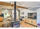 Inviting space with wood floors, open layout, fireplace, and view into kitchen at 7559 S Turkey Creek Rd, Morrison, CO 80465