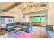Comfortable living room with exposed beams, a large painting, and ample natural light at 7559 S Turkey Creek Rd, Morrison, CO 80465