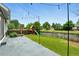 Fenced backyard with a grass lawn, patio, string lights and a playground at 1280 W 134Th Pl, Westminster, CO 80234