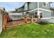 Fenced backyard has a garden area, a shade-covered storage shed, and grass at 1280 W 134Th Pl, Westminster, CO 80234