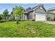 Charming home with a well-manicured lawn, an American flag, and a welcoming facade at 1280 W 134Th Pl, Westminster, CO 80234