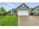 Charming home with a two-car garage and well-manicured front lawn and colorful flowerbed at 1280 W 134Th Pl, Westminster, CO 80234