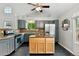 Charming kitchen with gray cabinets, island, stainless steel appliances, granite countertops and mosaic tile backsplash at 1280 W 134Th Pl, Westminster, CO 80234