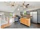 Bright kitchen featuring gray cabinets, an island, and stainless steel appliances, seamlessly connected to the living area at 1280 W 134Th Pl, Westminster, CO 80234