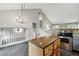 Kitchen island with granite top and breakfast bar is adjacent to the stairs at 1280 W 134Th Pl, Westminster, CO 80234