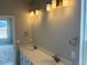 Bathroom featuring a double sink vanity with modern lighting and fixtures, offering a stylish and functional space at 1713 Jennifer St, Brighton, CO 80601