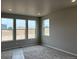 Bright bedroom with large windows offering ample natural light and a view of the surrounding area at 1713 Jennifer St, Brighton, CO 80601