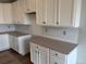 Bright kitchen featuring white cabinets, gray countertops, and modern finishes at 1713 Jennifer St, Brighton, CO 80601