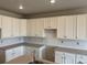 Bright kitchen featuring white cabinets, gray countertops, and contemporary finishes at 1713 Jennifer St, Brighton, CO 80601