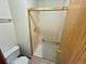 A shower with gold trim and neutral tile at 10716 Foxwood Ct, Parker, CO 80138