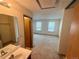 Bathroom with sink and mirror in the foreground with a view into a bedroom at 10716 Foxwood Ct, Parker, CO 80138