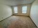Carpeted bedroom with two windows allowing in natural light at 10716 Foxwood Ct, Parker, CO 80138