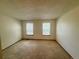 Carpeted bedroom with two windows allowing in natural light at 10716 Foxwood Ct, Parker, CO 80138