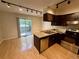 Kitchen featuring stainless steel appliances, dark cabinets, and hardwood floors at 10716 Foxwood Ct, Parker, CO 80138
