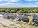 Wide aerial view showing modern homes in a well-planned community surrounded by trees and open fields at 5970 S Platte Canyon Dr, Littleton, CO 80123