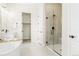 Elegant bathroom featuring a glass shower with tiled walls, walk in closet and modern fixtures at 5970 S Platte Canyon Dr, Littleton, CO 80123