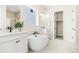 A luxurious bathroom featuring dual vanities, and a modern soaking tub at 5970 S Platte Canyon Dr, Littleton, CO 80123