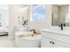 Bright bathroom featuring dual sinks, modern fixtures, and a soaking tub at 5970 S Platte Canyon Dr, Littleton, CO 80123