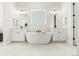 Elegant bathroom features dual sinks, soaking tub and contemporary lighting at 5970 S Platte Canyon Dr, Littleton, CO 80123