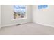 Bright bedroom boasts large windows and neutral carpet, creating a serene atmosphere at 5970 S Platte Canyon Dr, Littleton, CO 80123