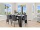 Modern dining room with a large window, an outside view, and a dining table set for six guests at 5970 S Platte Canyon Dr, Littleton, CO 80123