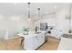 Well-lit kitchen featuring a large island with bar stools, stainless steel appliances and lots of cabinet space at 5970 S Platte Canyon Dr, Littleton, CO 80123
