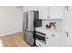 Kitchen with stainless steel refrigerator, microwave and white cabinets with plenty of countertop space at 5970 S Platte Canyon Dr, Littleton, CO 80123