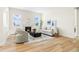 Bright living room with fireplace, wood floors, modern furniture, and two large windows at 5970 S Platte Canyon Dr, Littleton, CO 80123