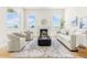 Well lit living room features wood floors, a fireplace and windows with outdoor views at 5970 S Platte Canyon Dr, Littleton, CO 80123
