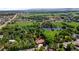 Aerial view of property featuring mature landscaping, a pond, and neighborhood surroundings at 12570 W 60Th Ave, Arvada, CO 80004