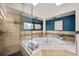 Luxurious bathroom features a soaking tub, tiled shower, and stylish fixtures at 12570 W 60Th Ave, Arvada, CO 80004