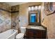 Bathroom featuring a combination tub and shower, granite countertop vanity, and dark wood cabinetry at 12570 W 60Th Ave, Arvada, CO 80004