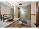 Bathroom with vessel sink, granite countertops, stone shower, and wood floors at 12570 W 60Th Ave, Arvada, CO 80004