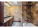 Bathroom featuring a combination tub and shower and dark wood cabinetry at 12570 W 60Th Ave, Arvada, CO 80004