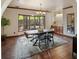 Inviting dining room features a large bay window, stylish light fixture and hardwood floors at 12570 W 60Th Ave, Arvada, CO 80004