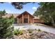Charming brick house showcasing a well-manicured garden, tile roof, and stone pathway at 12570 W 60Th Ave, Arvada, CO 80004