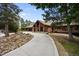 Stunning brick home featuring a three-car garage, tile roof, and meticulously maintained landscaping at 12570 W 60Th Ave, Arvada, CO 80004