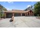 A spacious home with a tile roof and a three-car garage and generous driveway at 12570 W 60Th Ave, Arvada, CO 80004
