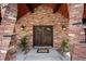 Inviting entryway with a beautiful double door, sconce lighting, and brick pillars at 12570 W 60Th Ave, Arvada, CO 80004