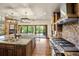 This bright kitchen includes granite counters, stainless appliances, stone backsplash, and island with sink at 12570 W 60Th Ave, Arvada, CO 80004