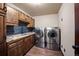 Convenient laundry room with tile floors, granite counters, and stainless washer and dryer at 12570 W 60Th Ave, Arvada, CO 80004