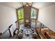 Open-concept living room boasting a stone fireplace, large windows, and vaulted ceilings at 12570 W 60Th Ave, Arvada, CO 80004