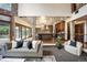 Open-concept living room flowing to the kitchen, featuring stone columns and ample seating at 12570 W 60Th Ave, Arvada, CO 80004